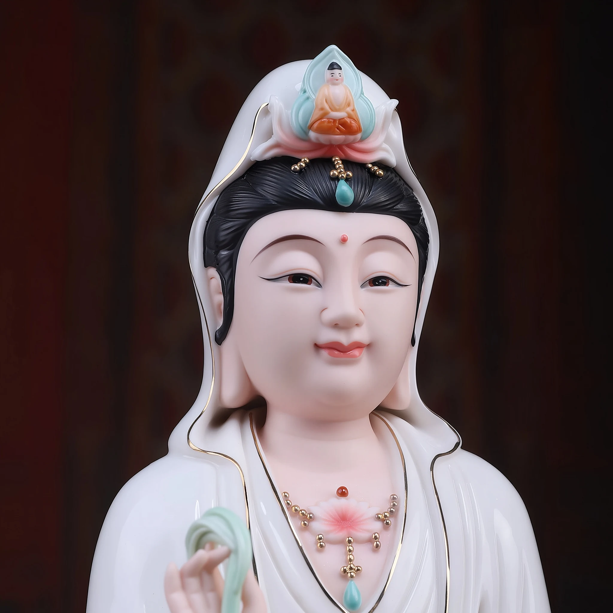Close-up of the Baoxiang Guanyin statue with painted eyes, a gentle smile and a small seated figure in the turquoise crown detail