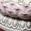 Pink-tipped lotus petals with fine grooves and gold-colored scroll outlines on the Guanyin pedestal