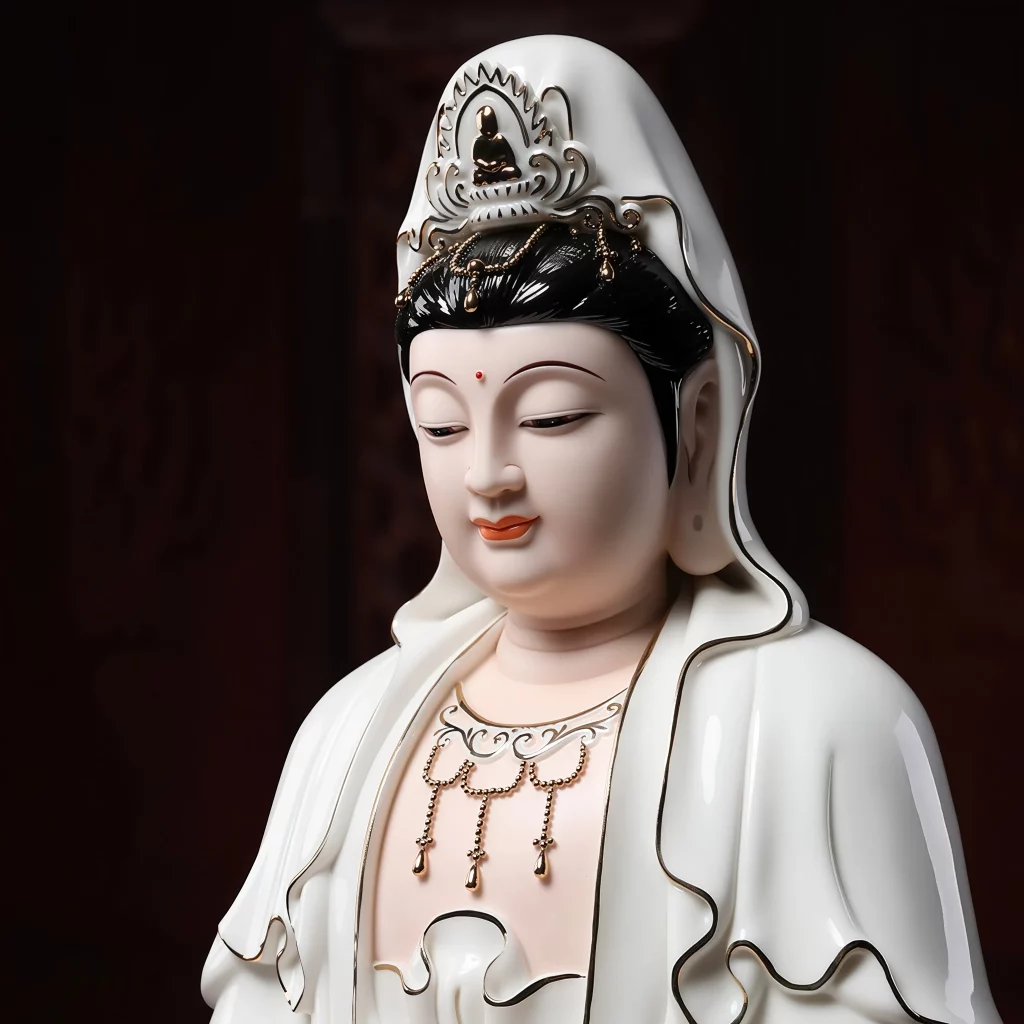 Painted Kuan Yin face and crown with black hair, a red forehead dot and delicate gold-colored trim