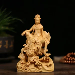 Front view of the golden boxwood Guanyin at ease, with one knee raised and a lotus blossom above curling waves
