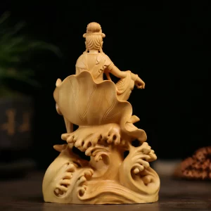 Boxwood Guanyin — lotus leaf rear view Rear view of the boxwood Guanyin statue showing the veined lotus leaf seat, carved hair and swirling wave base