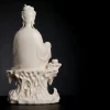 Back of Chijing Guanyin with smooth ivory-glazed robes, high hair bun and pierced rock seat