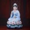 Front view of Cilian Guanyin in pale blue robes, holding a willow branch and vase above a pink lotus and blue waves