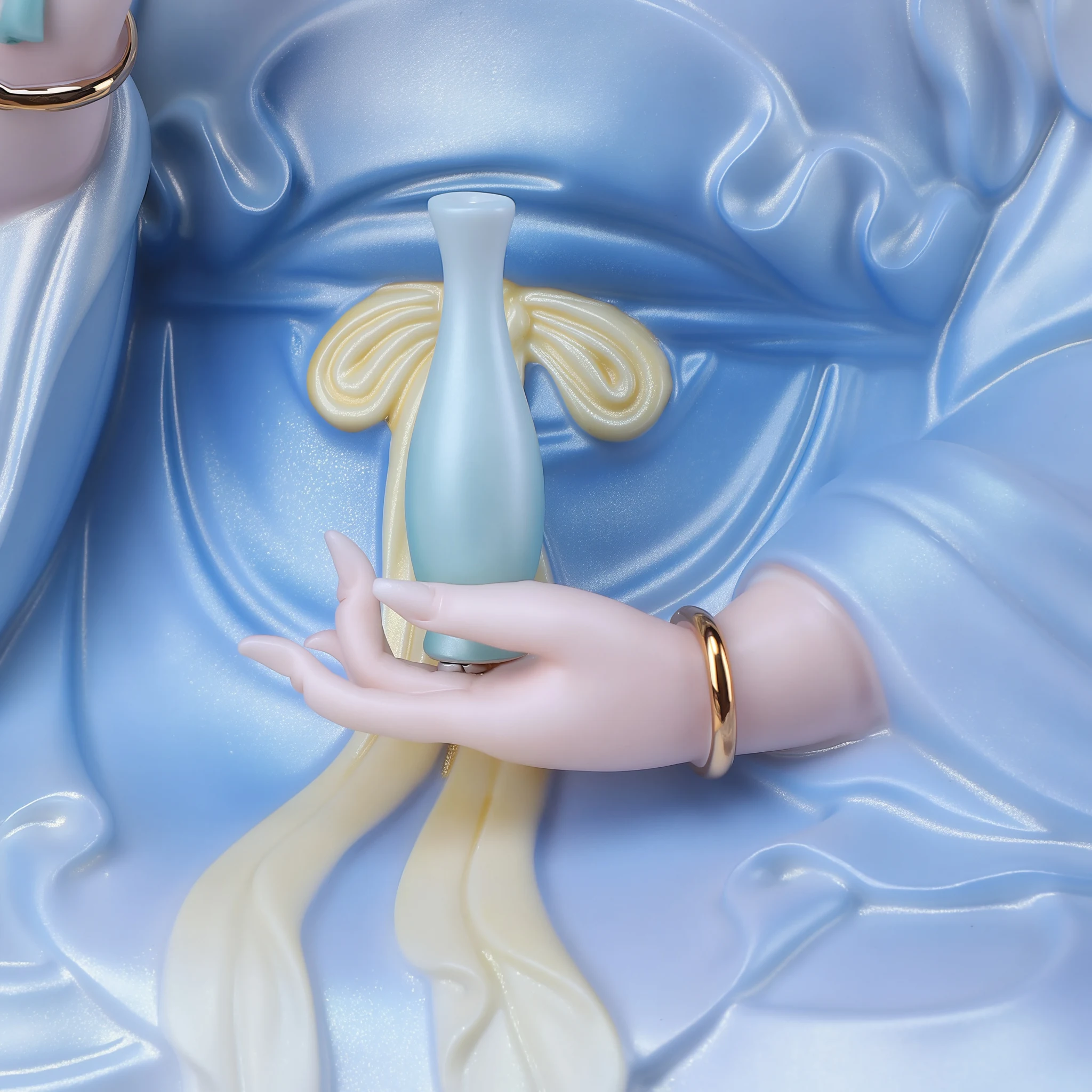 Cilian Guanyin’s hand supporting a pale green vase above the draped blue robe and crossed legs