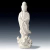 Full front view of the glazed white Dragon Guanyin statue, with crossed hands and a lotus leaf above a dragon and waves