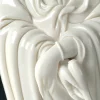 Crossed hands and draped sleeves of the white Dragon Guanyin statue