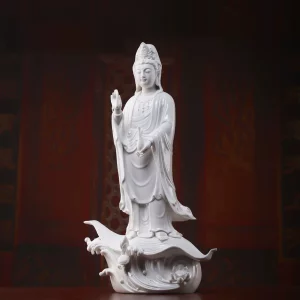 White porcelain Sea-Crossing Guanyin standing on a curling lotus leaf above sculpted waves, front view, 55 cm (21.7 in) tall