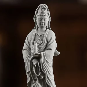 Sea-Crossing Guanyin Figurine — Face, vase and beads · detail of the front view Duhai Jingping Kuan Yin detail showing the face, slender vase, lowered hand and hanging beads