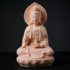 Front view of the 15 cm (5.9 in) peach pink Foguang Guanyin statue, with a flame-shaped halo, raised hand and vase on a lotus seat