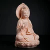 Three-quarter view of the small porcelain Foguang Kuan Yin statue, showing the halo, draped sleeves, vase and rounded lotus base
