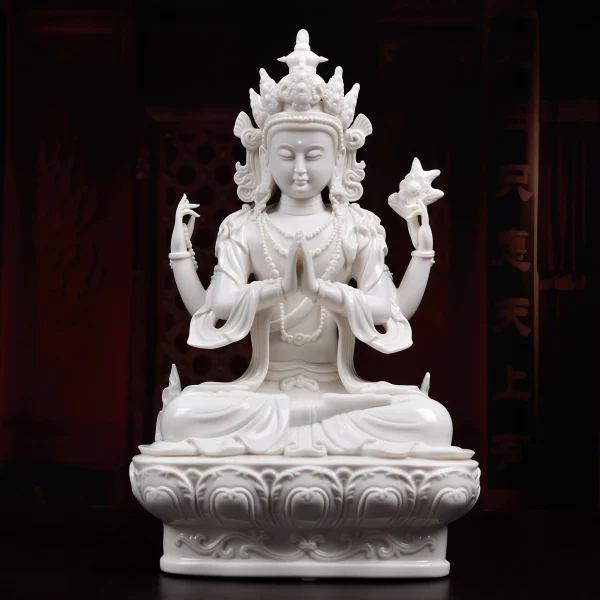 White porcelain Four-Armed Guanyin with joined palms, a raised lotus and a rounded lotus seat