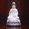 Front of a 30 cm (11.8 in) seated Guanyin statue in white with a purple lotus base and gold-colored accents