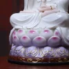 Purple and pink lotus petals above a carved pedestal with gold-colored scrollwork