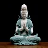 Front view of the 48 cm (18.9 in) teal Hezhang Guanyin statue, seated with joined palms beneath a tall ornamental crown
