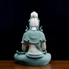 Back view of the teal Hezhang Guanyin statue showing sculpted hair, curling ribbons and an impressed mark