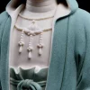 Raised necklace and speckled teal robe surface on the Jingsi Guanyin statue