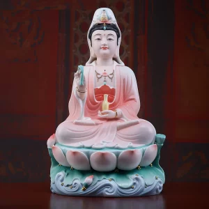 Jixiang Guanyin in pink & red robes, 41.5 cm (16.3 in), holding a leafy stem and pale yellow vase above pink-tipped lotus petals and a green and blue wave-pattern base
