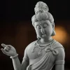 Liantai Guanyin close-up showing the inclined face, raised right hand, necklace and shoulder knot