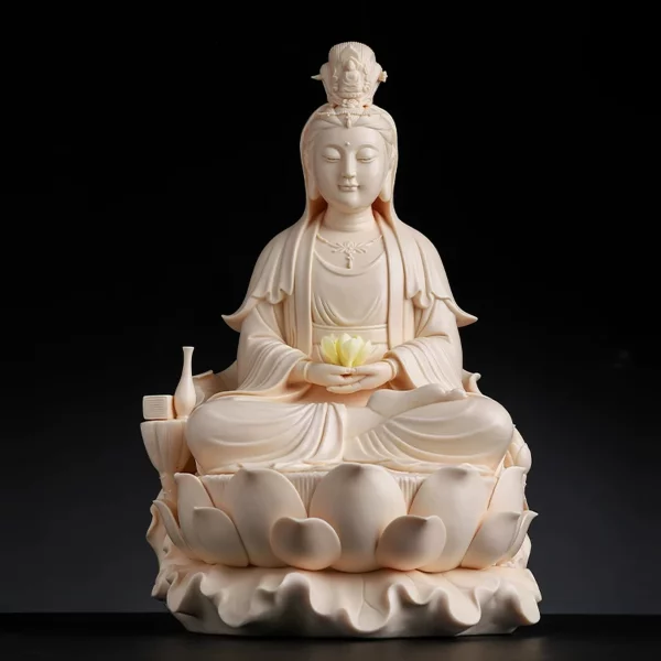 Warm cream Guanyin holding a yellow lotus in both hands, with a vase at the side and a folded leaf beneath the lotus seat
