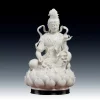 Front view of the white porcelain Lotus Ribbon Guanyin statue, holding a lotus above a layered lotus seat, on a black display stand