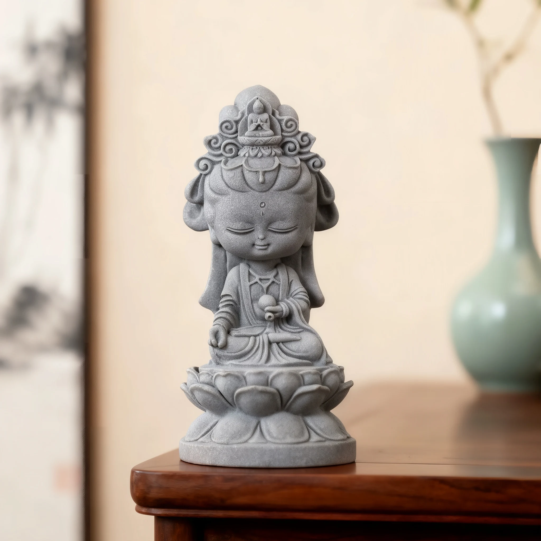 Gray Guanyin figurine displayed on a wooden tabletop beside a background vase