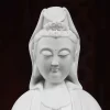 Close view of Nianzhu Kuan Yin’s lowered eyes, unpainted face and sculpted crown
