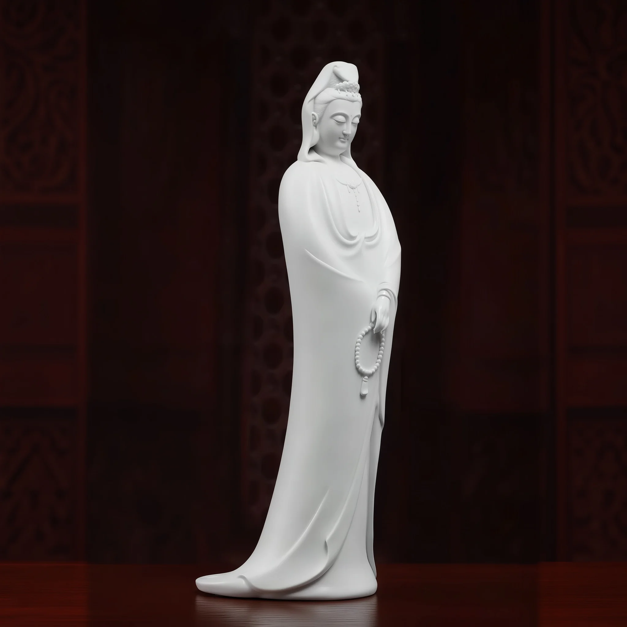 Right three-quarter view of the white porcelain Nianzhu Guanyin with flared robe hem