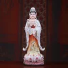 Painted porcelain standing Guanyin statue, 36 cm (14.2 in), with white and amber robes on a pink lotus base