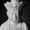 Close-up of the lowered eyes and sculpted crown on the 22 cm (8.7 in) Pilu Guanyin statue in white porcelain