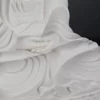 Hands resting one above the other across the lap, surrounded by robe folds on the 22 cm (8.7 in) Pilu Guanyin statue in white porcelain