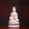 Pink porcelain Guanyin holding a green willow branch and gold-colored vase; front view on a rounded lotus, 35 cm (13.8 in) tall