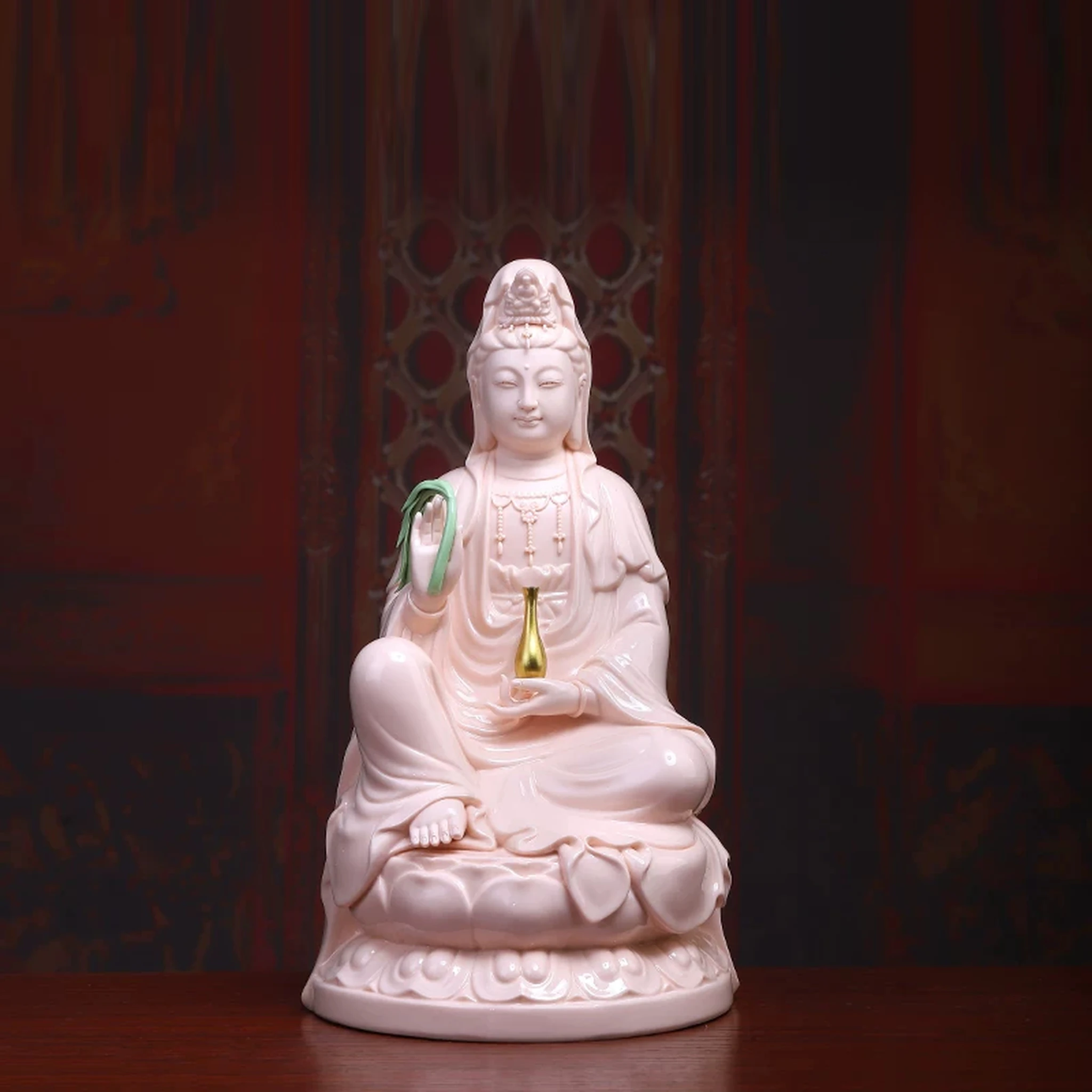 Pink porcelain Guanyin holding a green willow branch and gold-colored vase; front view on a rounded lotus, 35 cm (13.8 in) tall