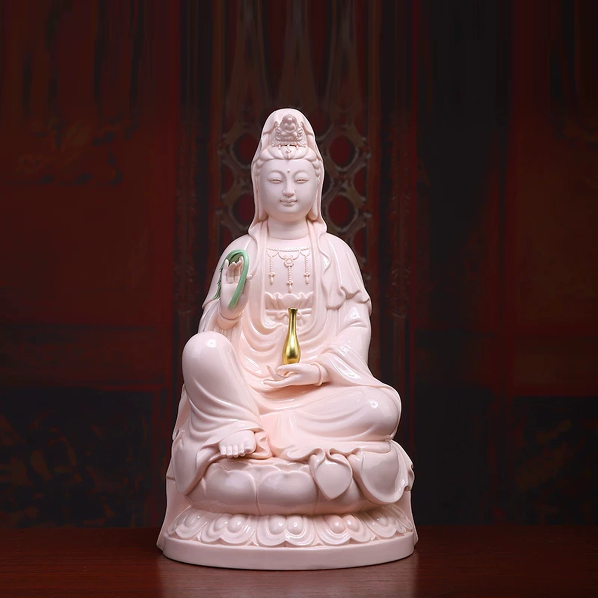 Pink porcelain Guanyin holding a green willow branch and gold-colored vase; front view on a rounded lotus, 39.5 cm (15.6 in) tall