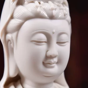 Lowered eyes and softly modeled lips on the 29.5 cm (11.6 in) white porcelain Hezhang Guanyin