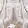 Fingers pressed together above glossy sleeve cuffs on the 29.5 cm (11.6 in) Guanyin statue