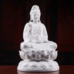 Quanlian Guanyin — White — Three-quarter view Three-quarter view of the white Quanlian Kuan Yin statue, showing the raised hand, vase, robe folds and rounded lotus pedestal