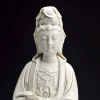 Face and crown of the white Ruyi Guanyin statue, with lowered eyes