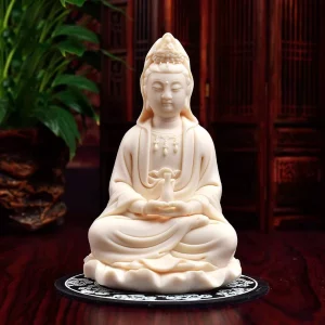 Front view of a pale peach Zuohe Guanyin holding a slender vase in both hands, seated on a folded lotus leaf, 14.5 cm (5.7 in) tall