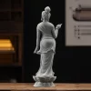 Rear view of the standing Kuan Yin statue, showing gathered hair, diagonal drapery and the lotus base