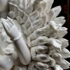 Close-up of the overlapping porcelain hands radiating beside Qianshou Guanyin