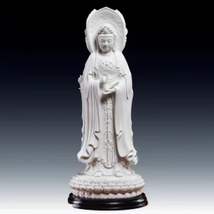 Unglazed white Nanhai Three-Faced Guanyin holding a scripture scroll above a lotus pedestal and black stand