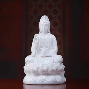 Front view of the 20 cm (7.9 in) Pure White porcelain Guanyin statue seated on a lotus pedestal.