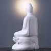 Rear three-quarter view of the 29 cm (11.4 in) Pure White porcelain Guanyin statue, showing the draped robe and lotus-leaf base.