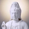 Close-up of the face, crown and beaded necklace on the 29 cm (11.4 in) Pure White porcelain Guanyin statue.