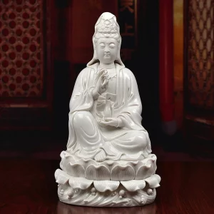 White seated Willow Branch Guanyin statue with one knee raised, a willow sprig, slender vase and lotus pedestal above sculpted waves