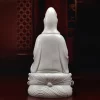 Back of the white Yangzhi Guanyin statue, showing long robe folds and the tied motif above the wave relief