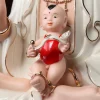 Boy with single top hair tuft, red bib and curved ornament on Xiangyun Songzi Guanyin’s lap