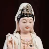 Songzi Kuan Yin’s painted face and crown above the boy with single top hair tuft