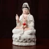 Angled view of the ceramic Songzi Guanyin with boy, red bib and lotus petals above the cloud base