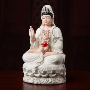 Angled view of the ceramic Songzi Guanyin with boy, red bib and lotus petals above the cloud base